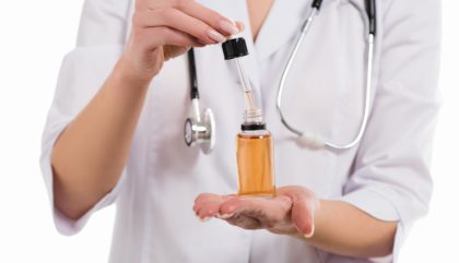 doctor holding cbd oil bottle